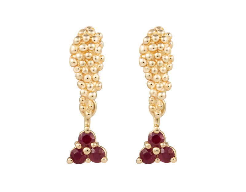 Pair of yellow gold studs in the shape of a bunch of grapes carved in detail in relief. Hanging from the bottom are trios of round red rubies forming a triangle.