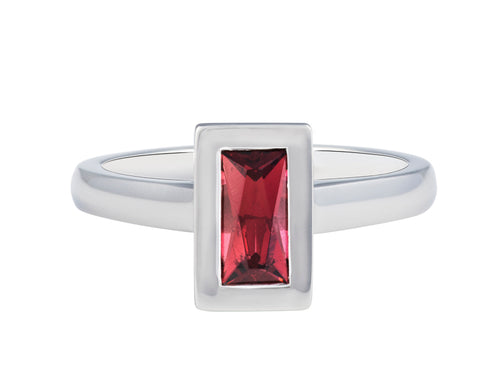 Platinum ring set with raspberry red rhodolite garnet in a frame, bezel. The gem is a thin rectangle lying parallel to the finger. Setting is raised above the band.