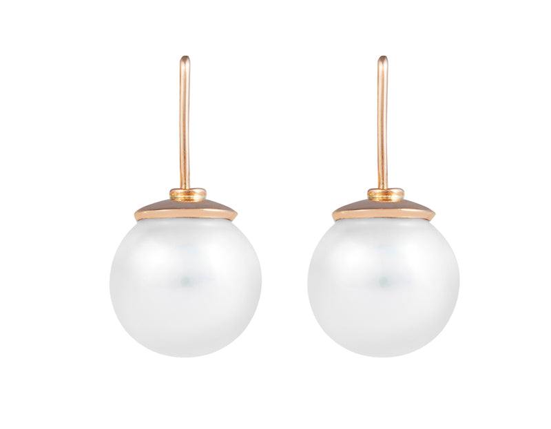 Large white pearls with rose gold caps on rose gold shepherd's hooks.