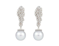 Pair of platinum studs in the shape of a bunch of grapes carved in detail in relief. Hanging from the bottom are silver blue pearls with a platinum cap.
