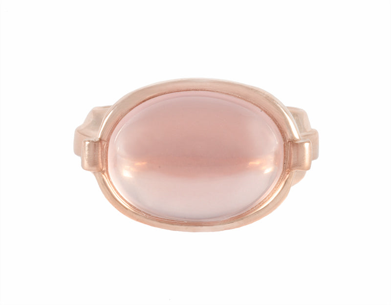 Oval rose quartz cabochon in 18k rose gold ring.