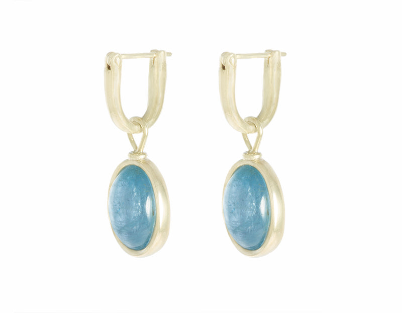 Natural aquamarine oval cabochons on 18k green  gold hoops.