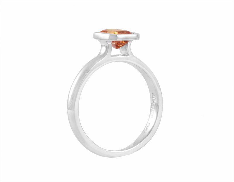 Orange spessartite garnet in platinum ring.