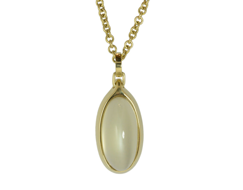 Very large oval green moonstone set in green gold frame and chain.