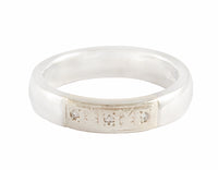 Platinum band with three diamonds.