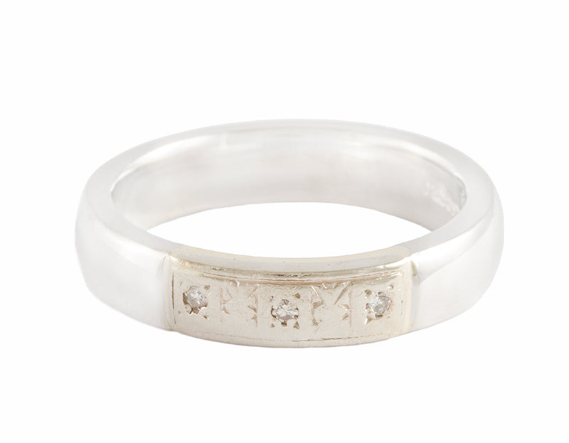 Platinum band with three diamonds.