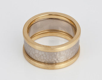 Hammered white gold band with yellow gold rims.