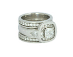 White gold ring with large diamond, accent diamonds and pear shaped diamonds, plus matching bands with diamonds.