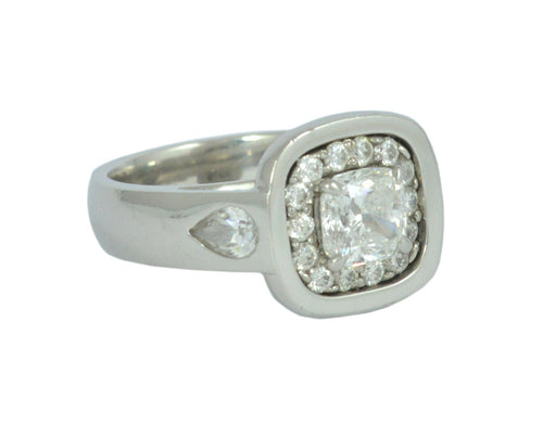 White gold ring with large diamond, accent diamonds and pear shaped diamonds.