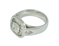 White gold ring with large diamond, accent diamonds and pear shaped diamonds.