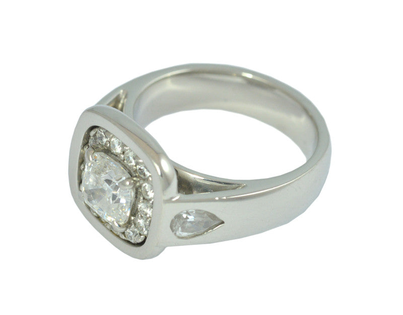 White gold ring with large diamond, accent diamonds and pear shaped diamonds.