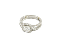 White gold ring with large diamond, accent diamonds and pear shaped diamonds, plus matching band with diamonds.