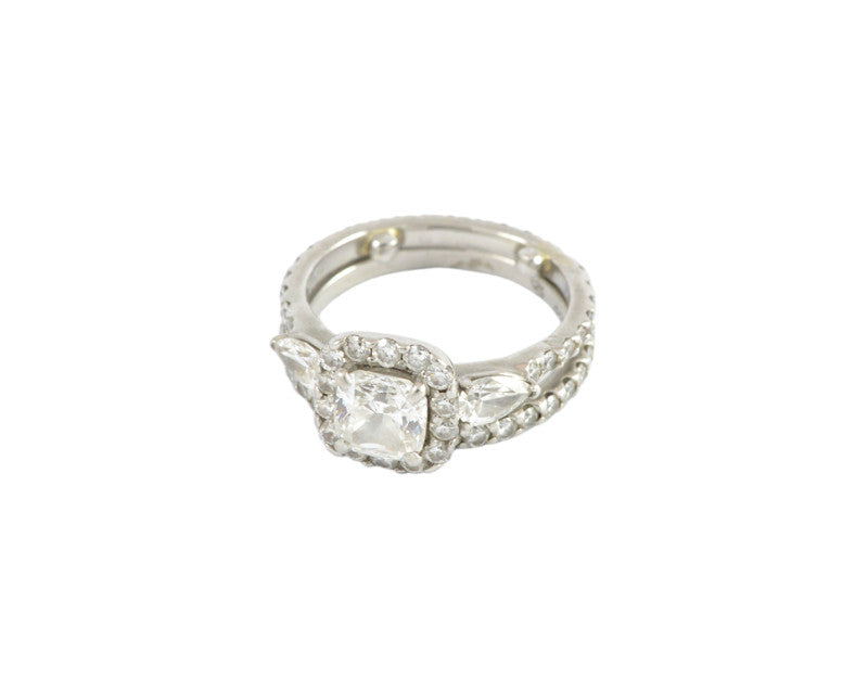 White gold ring with large diamond, accent diamonds and pear shaped diamonds, plus matching band with diamonds.