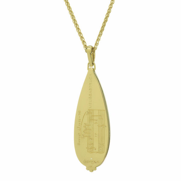 Large white teardrop moonstone pendant in green gold with Pierrot Lunaire engraving, on green gold chain.