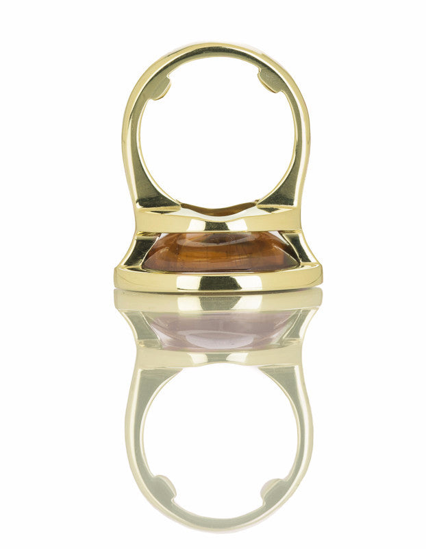 Golden zircon cabochon gem set in green gold ring.