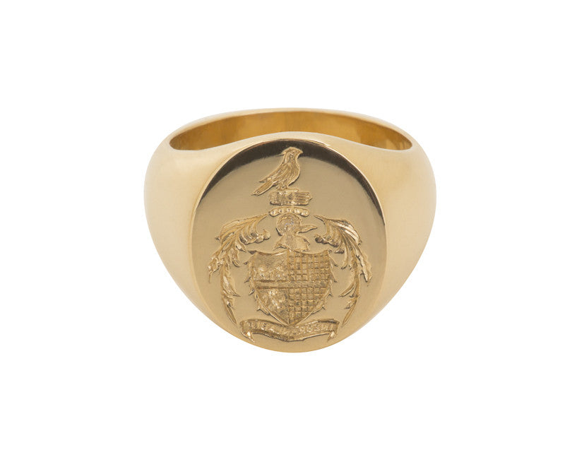 Man's signet ring, engraved family crest in yellow gold.