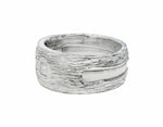 Wide Platinum man's band, textured like bark, set with three square diamonds.