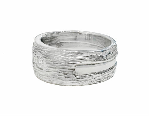 Wide Platinum man's band, textured like bark, set with three square diamonds.