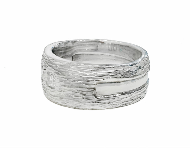 Wide Platinum man's band, textured like bark, set with three square diamonds.