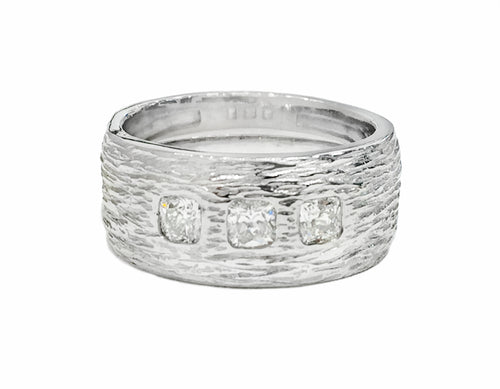 Wide Platinum man's band, textured like bark, set with three square diamonds.