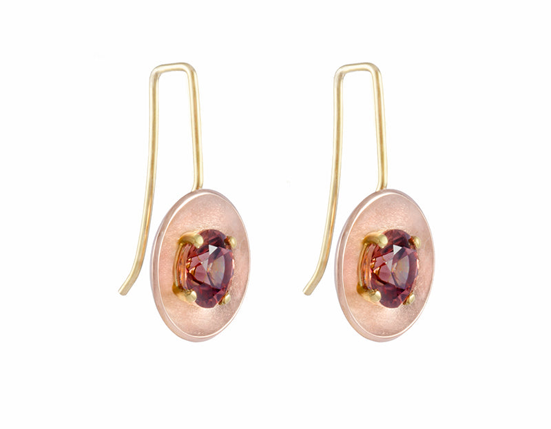 Drop earrings with yellow gold wires and rose gold bowls. Bright brandy coloured faceted gems prong set in each bowl.