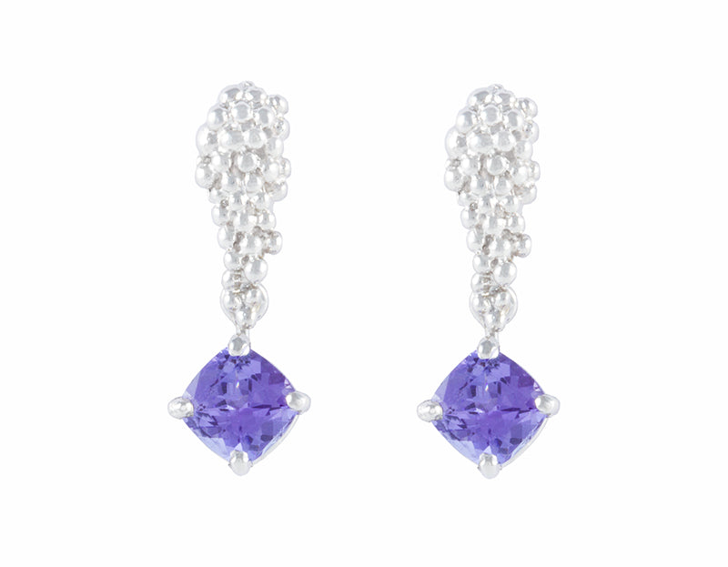 Studs in platinum like a bunch of grapes. Blue-purple tanzanite gems hanging from the ends. 