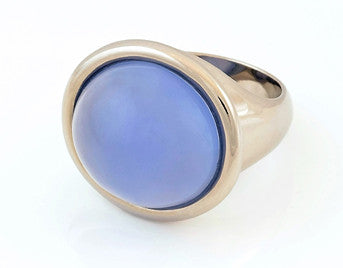 Very large white gold ring set with large round cabochon of bright denim blue chalcedony. Gem is set in frame and goes beyond width of finger.